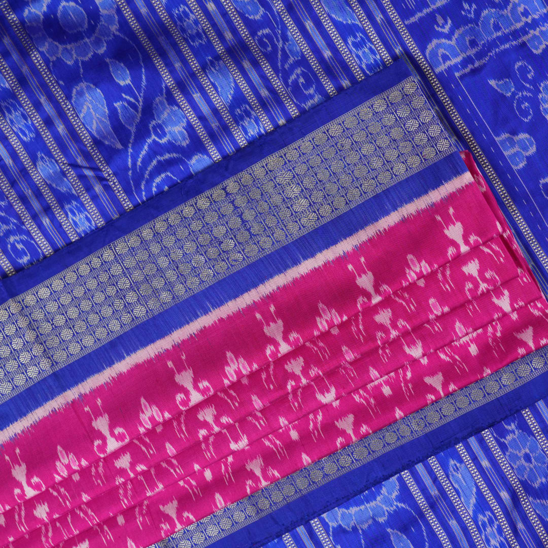 Close-up showing the luxurious handloom silk fabric texture and fine weave of the pink Sambalpuri saree.