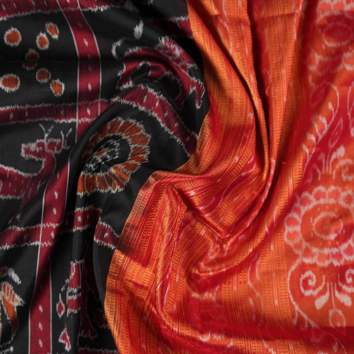 Close-up of Sambalpuri silk saree fabric, revealing rich texture, weave, and subtle tissue motifs.