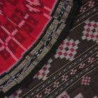 Model showcasing an elegant drape of a red and black Sambalpuri cotton handloom saree with traditional motifs